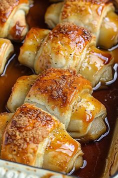 baked pastry items in a baking dish ready to be eaten with sauce on the side