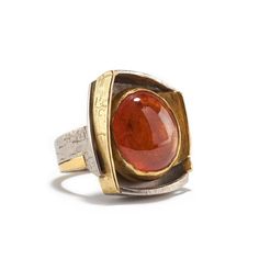 18K yellow & white gold, 23.30cts spessertite garnet A blip from an isolated corner of deep space. A flash of orange, an instant captured forever, a spot on a distant sun. A pulsar that communicates in color, not sound, looking for a response. What's yours? This warm orange spessartite garnet has a glowing quality, which for contrast Alexandra entrapped in 18K palladium white gold (it is warmer and grayer than usual white gold). One side however is open and oozes 24K yellow gold down the sha Word Press, Spessartite Garnet, Carving Patterns, Chinese Jade, Coral Necklace, Garnet Ring, Disc Necklace, Deep Space, Garnet Rings