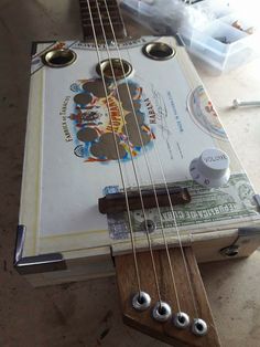 an old ukulele is sitting on the floor