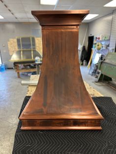 an old fashioned wooden stove hood in a shop