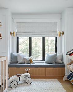 a child's room with a window seat and toys