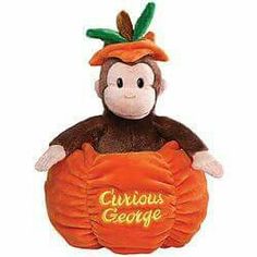 a stuffed monkey with a sign that says curious george on it's chest and holding an orange ball