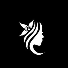 the silhouette of a woman's face with leaves on her head, in black and white