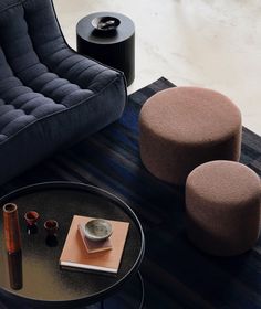 a living room with two chairs and a coffee table on top of carpeted flooring