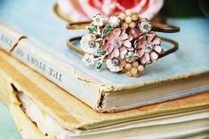 a ring with flowers on it sitting on top of a book