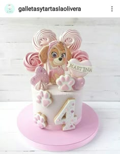 a birthday cake for a girl with a dog on top and pink icing around it