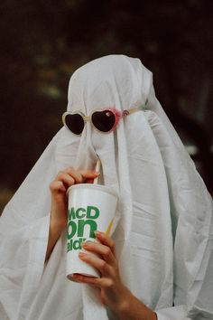 a person in a nun costume holding a cup