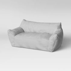 a white couch sitting on top of a white floor