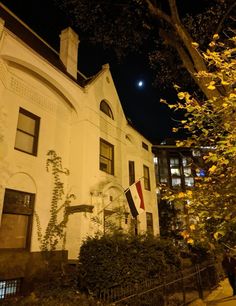 a large white building with a flag on it's side