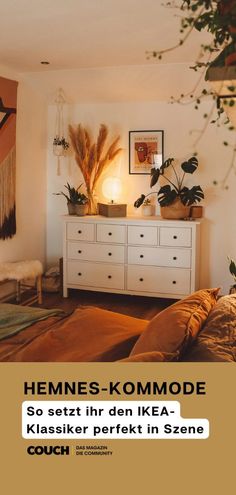 a bed room with a neatly made bed next to a dresser and potted plants