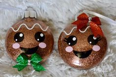 two christmas ornaments with faces on them