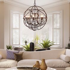 a living room filled with furniture and a chandelier hanging over the top of it