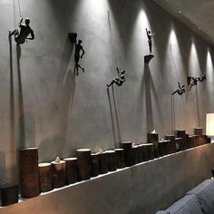 a room with sculptures on the wall and lamps