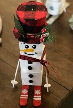 a snowman made out of paper sitting on top of a wooden table