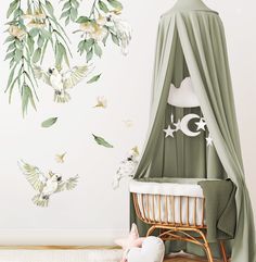 a baby's room decorated in green and white with birds flying around the crib