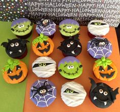 cupcakes decorated as witches and pumpkins on top of an orange tablecloth