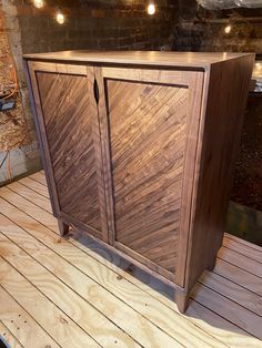 a wooden cabinet sitting on top of a wooden floor