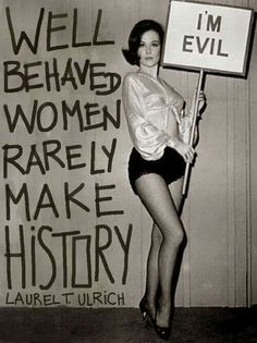 a woman holding a sign that says well, i'm evil and behaved women rarely make history