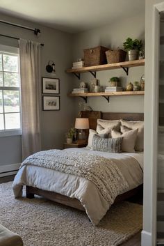 a bed sitting in a bedroom next to a window with open shelves on the wall