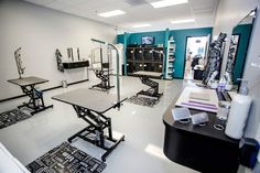 a room with tables, chairs and other items on the floor in front of them