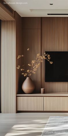 a vase with flowers in front of a flat screen tv on a wooden entertainment center