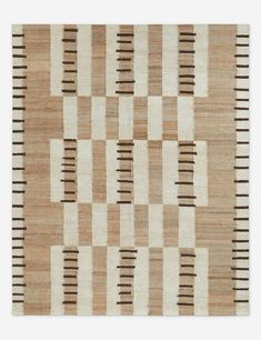 an area rug with squares and lines on it in brown, beige and white colors