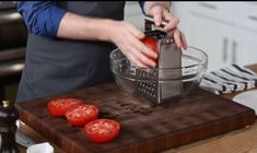 a person grating tomatoes in a bowl on a cutting board