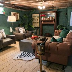 a living room filled with furniture and green walls