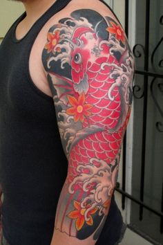 a man with a tattoo on his arm has a koi fish in the water