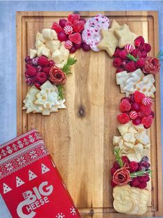 a christmas wreath made out of crackers and raspberries