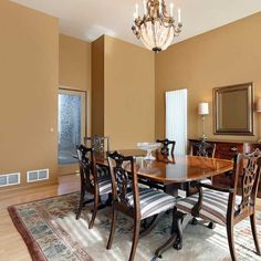 a dining room table with chairs and a chandelier