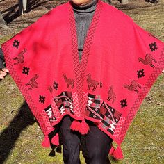 a woman wearing a red shawl with horses on it