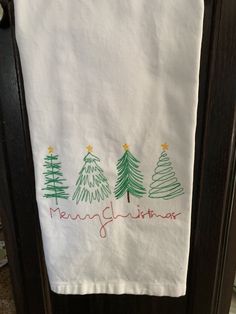 a kitchen towel with christmas trees on it