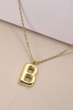 18K Stainless Steel Tarnish-Free Bubble Balloon Letter Gold-Dipped Stainless Steel Initial Monogram Necklace, made from high-quality stainless steel with a luxurious 18K gold finish, this necklace features a charming bubble-style initial pendant.Product Details:length: 18"charm: .70" x .60"ext: 3"clasp: Lobster ClawMetal finish: Stainless Steel 18K Goldproduct: Lead & Nickel Compliantanti-tarnish: Tarnish Free, Non-TarnishReal Gold Dipped NecklaceStainless Steel NecklaceHypoallergenic NecklaceTa Bridal Candles, Tyler Candle Company, Barefoot Dreams Blanket, Golf Socks Women, Letter Charm Necklace, Scout Bags, Bubble Style, Clear Purses