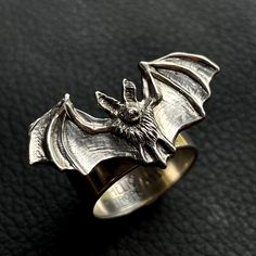 "Solid sterling silver Pallid Bat Ring. Original design was meticulously hand carved, creating a tiny sculpture based on photos of the real animal. Cast in small batches. Bat wingspan measures 1.25\" across. Other bat designs available, see other listings. Species: Pallid bat, Antrozous pallidus" Novelty Silver Ring Jewelry, Collectible Vampire Jewelry For Halloween, Unique Hand Cast Rings For Halloween, Symbolic Collectible Halloween Jewelry, Unique Sterling Silver Halloween Rings, Unique Sterling Silver Rings For Halloween, Unique Silver Rings For Halloween, Silver Novelty Jewelry For Halloween, Unique Silver Halloween Jewelry