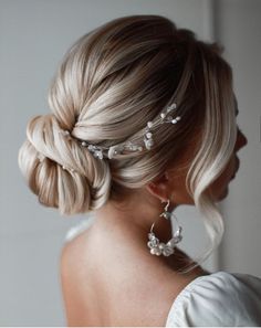 a woman with blonde hair wearing a wedding hairstyle