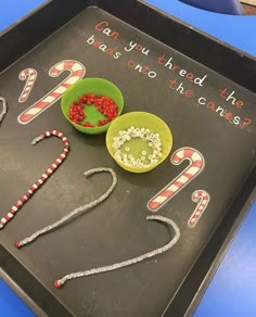 a tray that has some candy canes in it