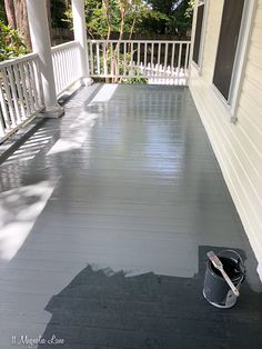 a paint can is sitting on the porch