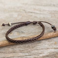 Braided by hand strands of brown leather encircle the wrist in a bracelet for men. Chaloemphon adds ivory and dark brown beads carved of bone to this design. The length can be adjusted by sliding the knot along the cord. Cheap Brown Men's Bracelets, Masculine Jewelry, Mens Bracelet Designs, Gyeongju, Wrist Jewelry, Titanium Bracelet, Jewelry Men, Mens Braids, Titanium Jewelry