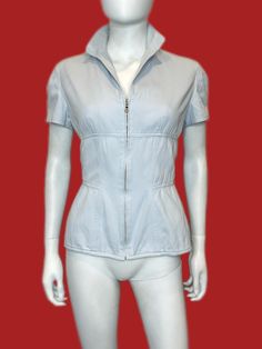 https://www.instagram.com/poplife.lv/ * stylish vintage piece by Mugler MTM Trademark * lightweight pale light blue ribbed cotton corset style top with zipper, short sleeve, fitted * sleeves with side slits * bit stretchy, 98% cotton 2% lycra * fits to M size * light yellowish wear dirt on the left side near armpit, almost not not visible * measurements: armpit to armpit 50cm waist taken flat 38cm bottom taken flat 44cm  shoulder to shoulder 40cm sleeve 17cm length from shoulder 58cm * shipping Mugler Corset Top, Military Style Collared Top With Snap Buttons, Vintage Washed Blue Top With Button Closure, Washed Blue Button-up Top With Patch Pockets, Cotton Corset, Corset Style Tops, Corset Style, Womens Clothing Tops, Top Styles