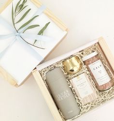 an open gift box containing two bottles of body care products