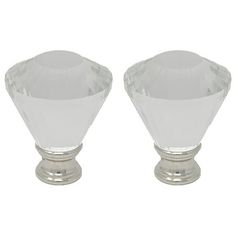 pair of crystal glass knobs on silver plated bases, each with a unique design