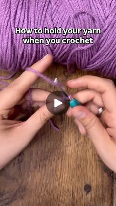 two hands are knitting yarn on a wooden table with the words how to hold your yarn when you crochet