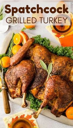 a roasted turkey on a platter with oranges, herbs and other food items