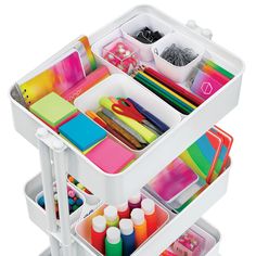 a white cart filled with lots of craft supplies