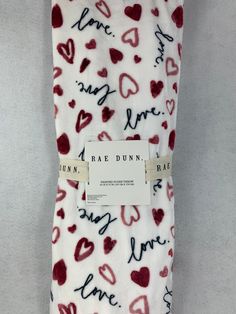 a white and red tie with hearts printed on the bottom, along with an i love you tag that says rad dunk bake