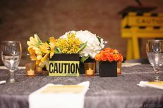 the table is set with flowers and place cards for guests to sign in their name