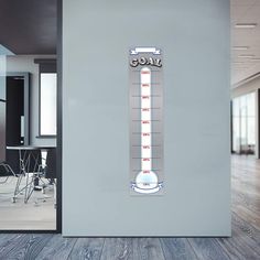 a thermometer mounted on a wall in an office