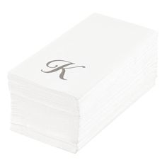 a stack of white napkins with the letter f on it