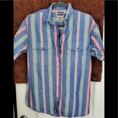 Vintage Striped Button Down Denim Multi Colored Stripes 100% Cotton Tag Size M Measurements: Bust 22 Inches Length 27 Inches (Front) 28 Inches (Back) Sleeves 9.5 Inches $29 Casual Blue Shirt With Buttoned Pockets, Light Wash Summer Shirt With Buttons, Light Wash Shirt With Buttons For Summer, Summer Light Wash Shirt With Buttons, Light Wash Buttoned Shirt For Summer, Light Wash Button Shirt For Summer, 90s Style Spring Tops With Buttons, 90s Style Blue Shirt For Spring, Blue 90s Style Shirt For Spring